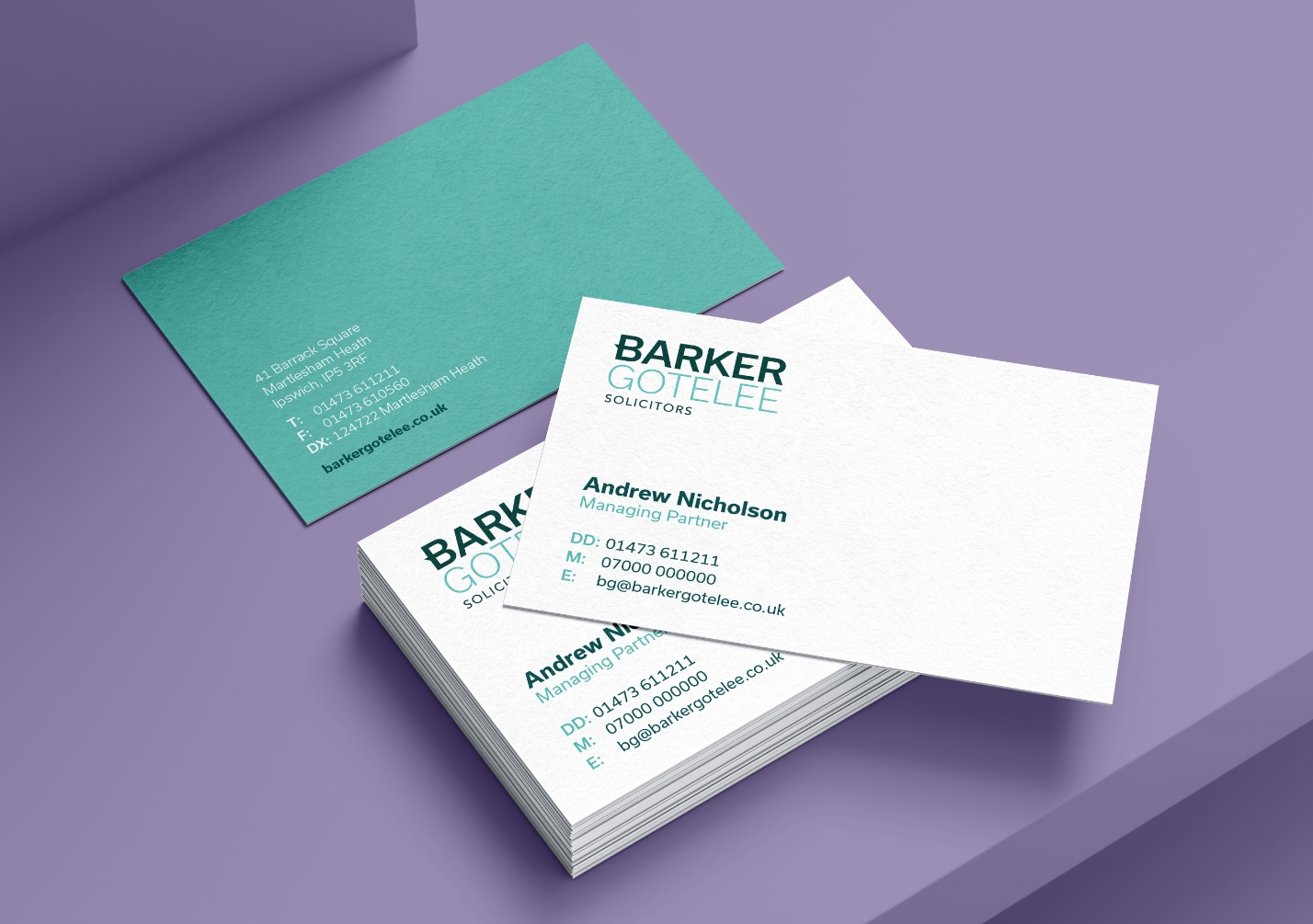 Barker Gotelee rebranded business cards on a purple background