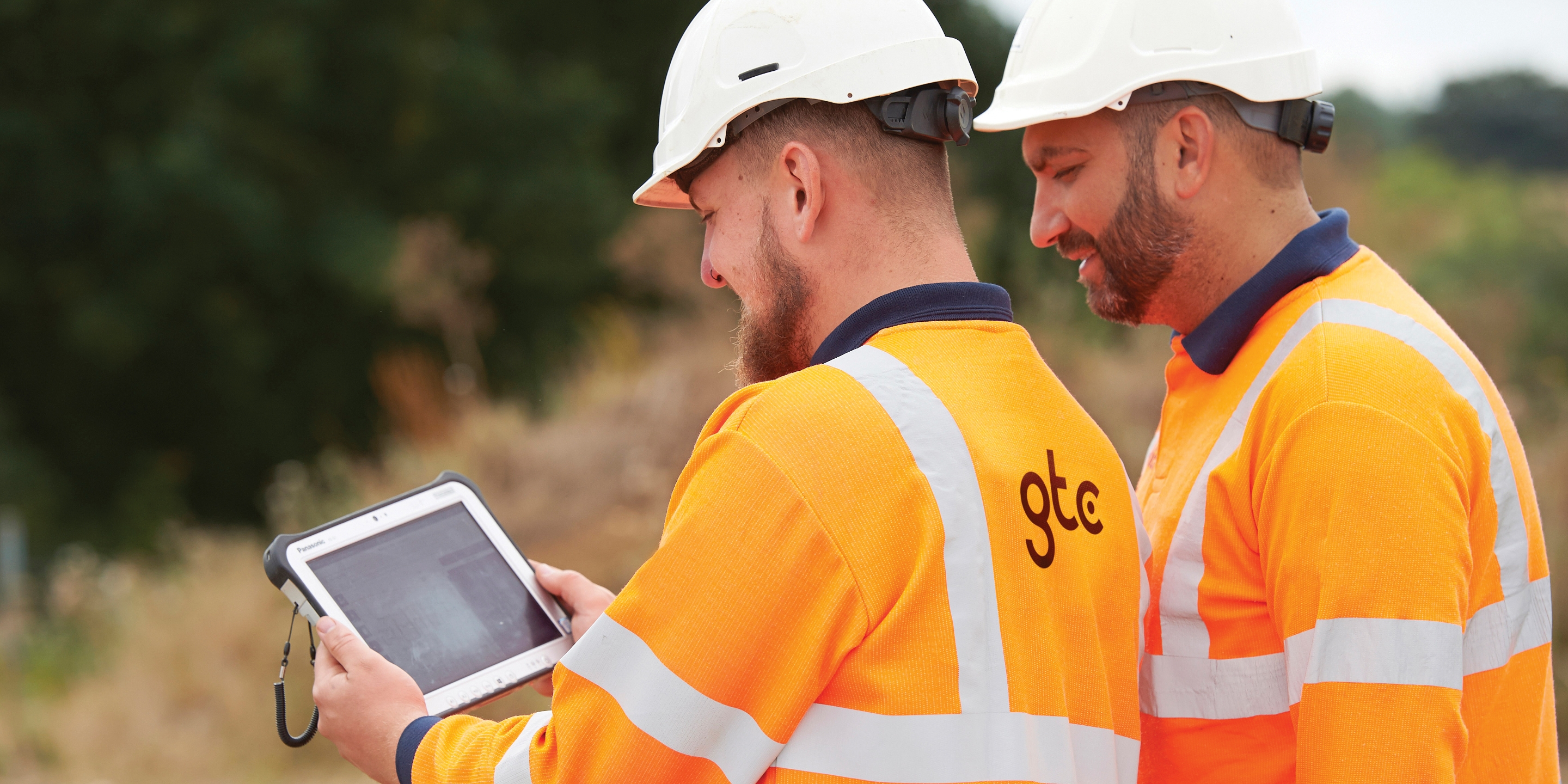 Workman wearing a high-vis jacket with the GTC logo