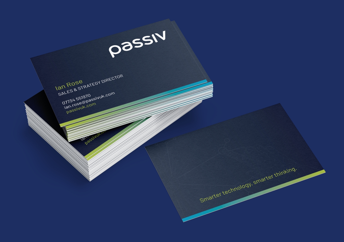 Stack of Passiv business cards on a blue background