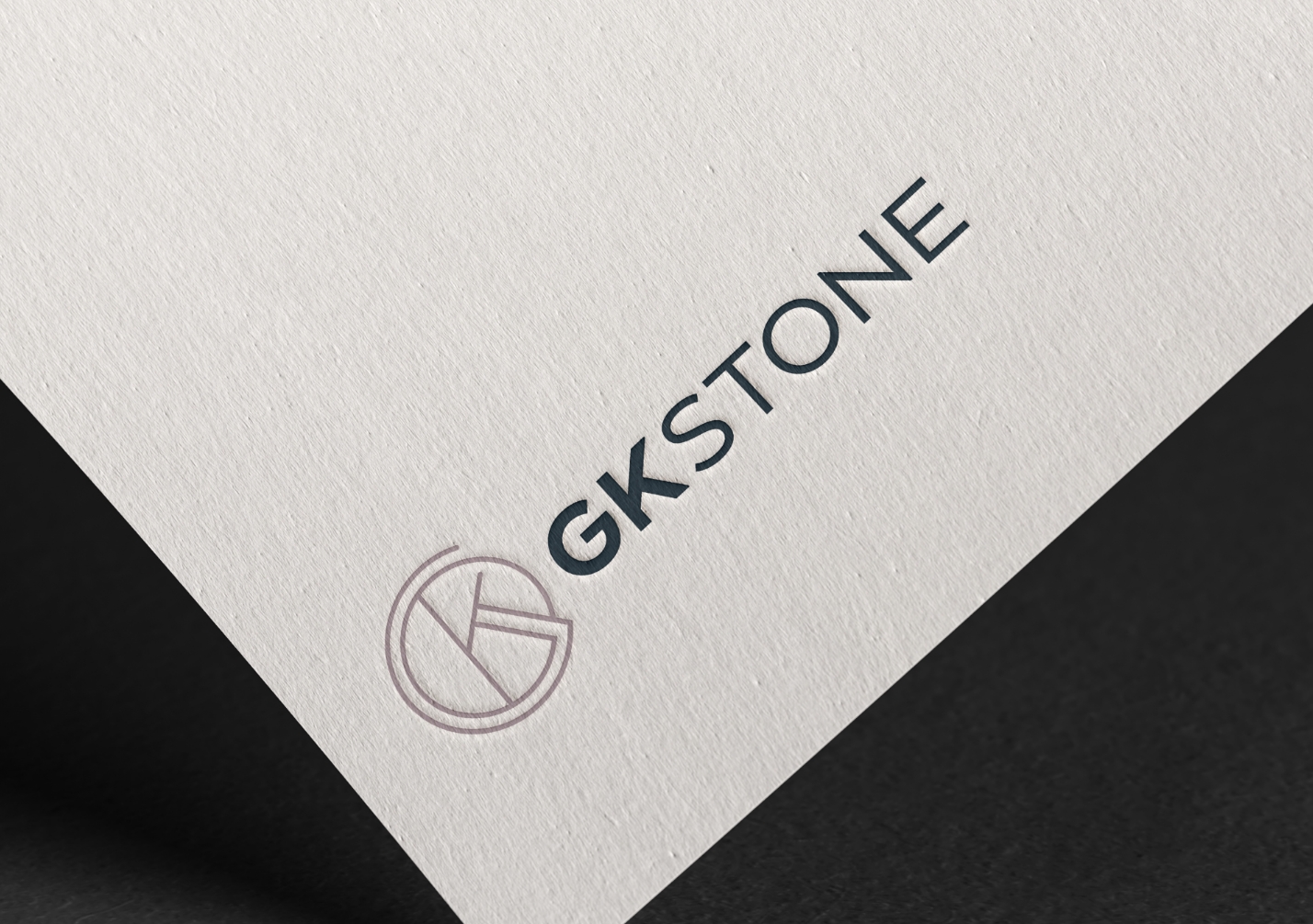 GK Stone logo design shown on a paper mockup